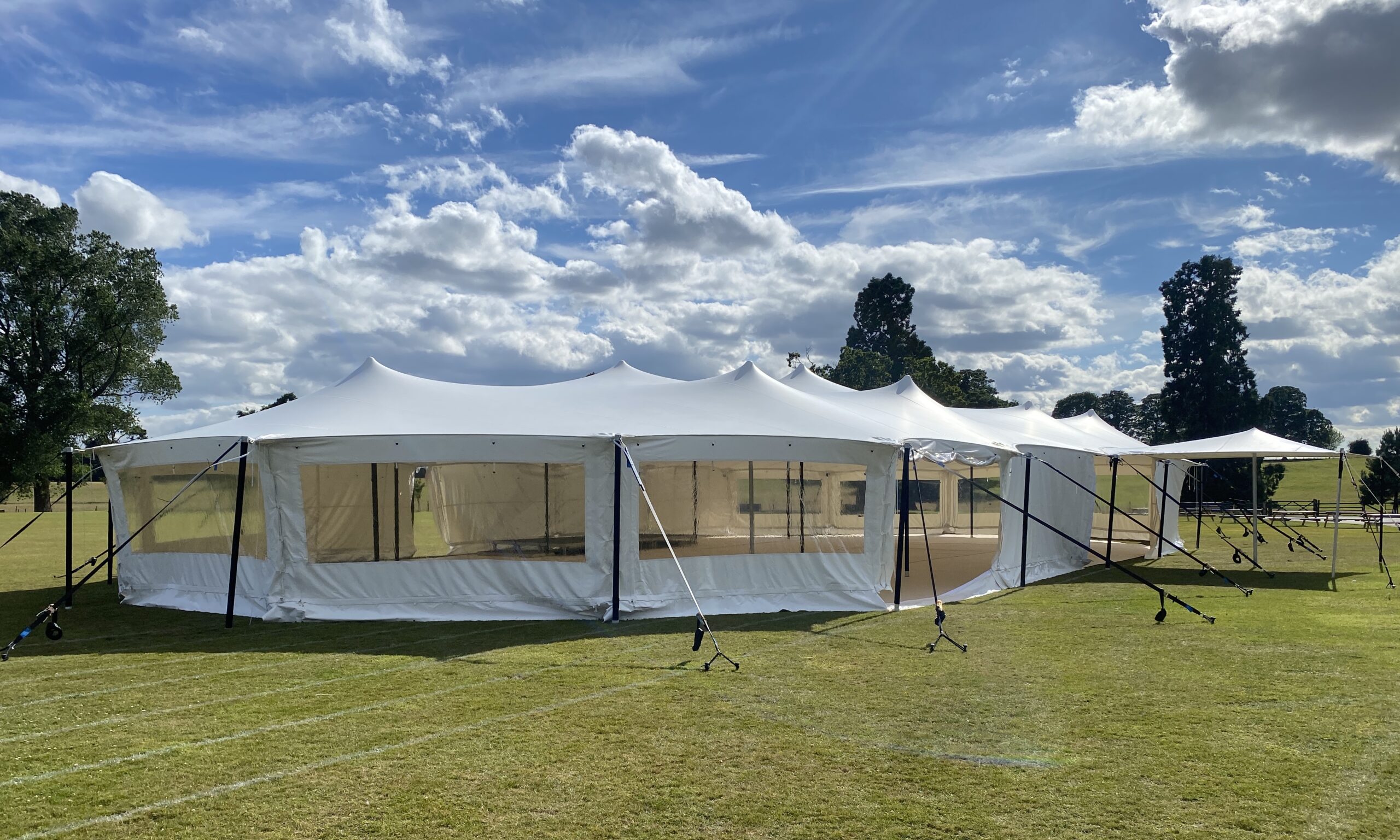 A large white stretch tent marquee with windows