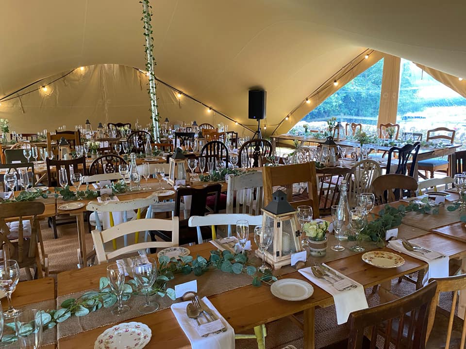 stretch tent interior with rustic wooden furniture