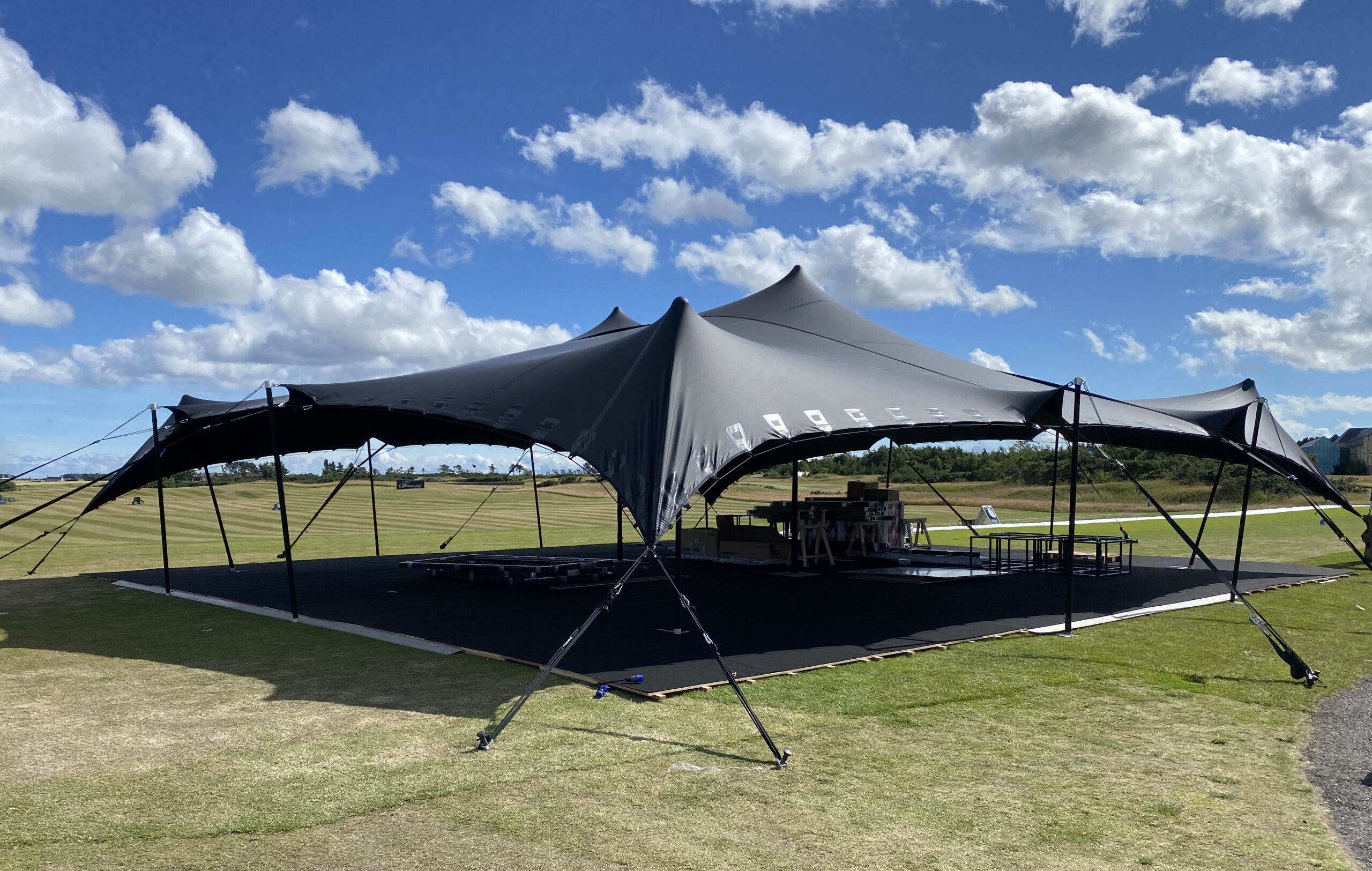 Black stretch tent with hard flooring for corporate event