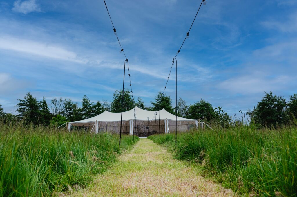 white marquee / stretch tent with walls by countryside events, wedding tent in field