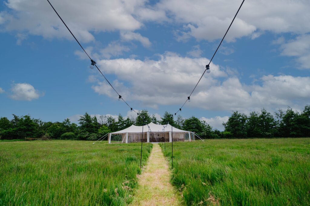 white marquee / stretch tent with walls by countryside events, wedding tent in field