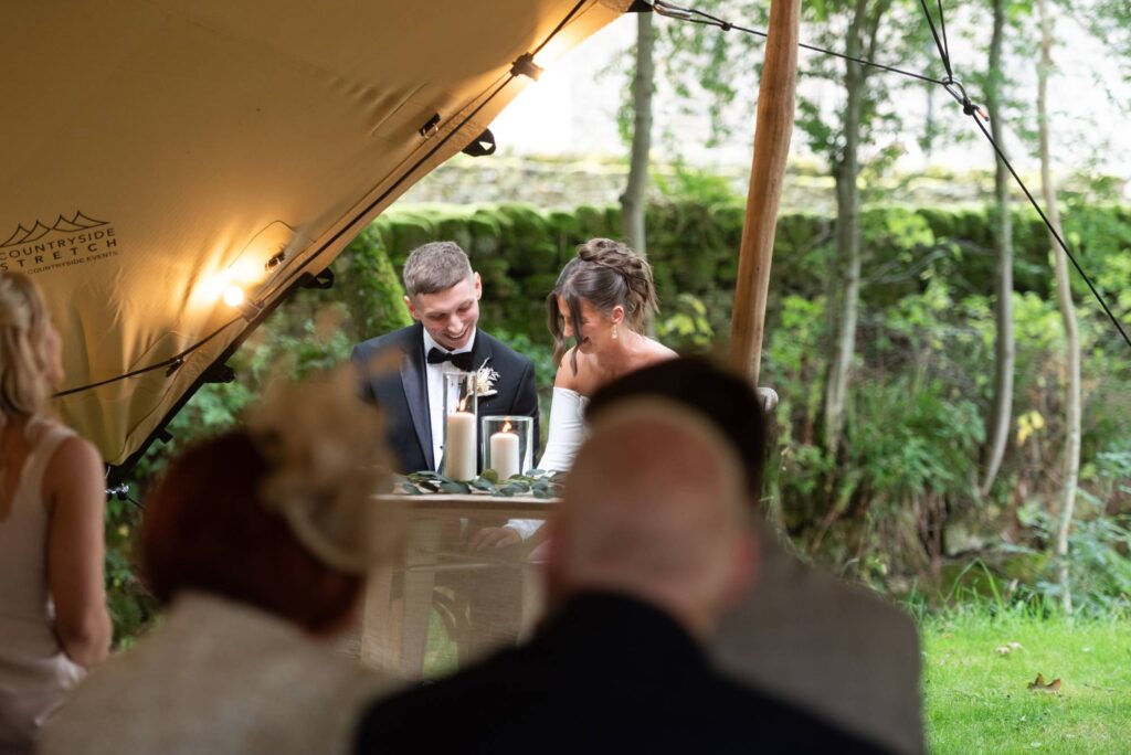 bride and groom signing wedding certificate