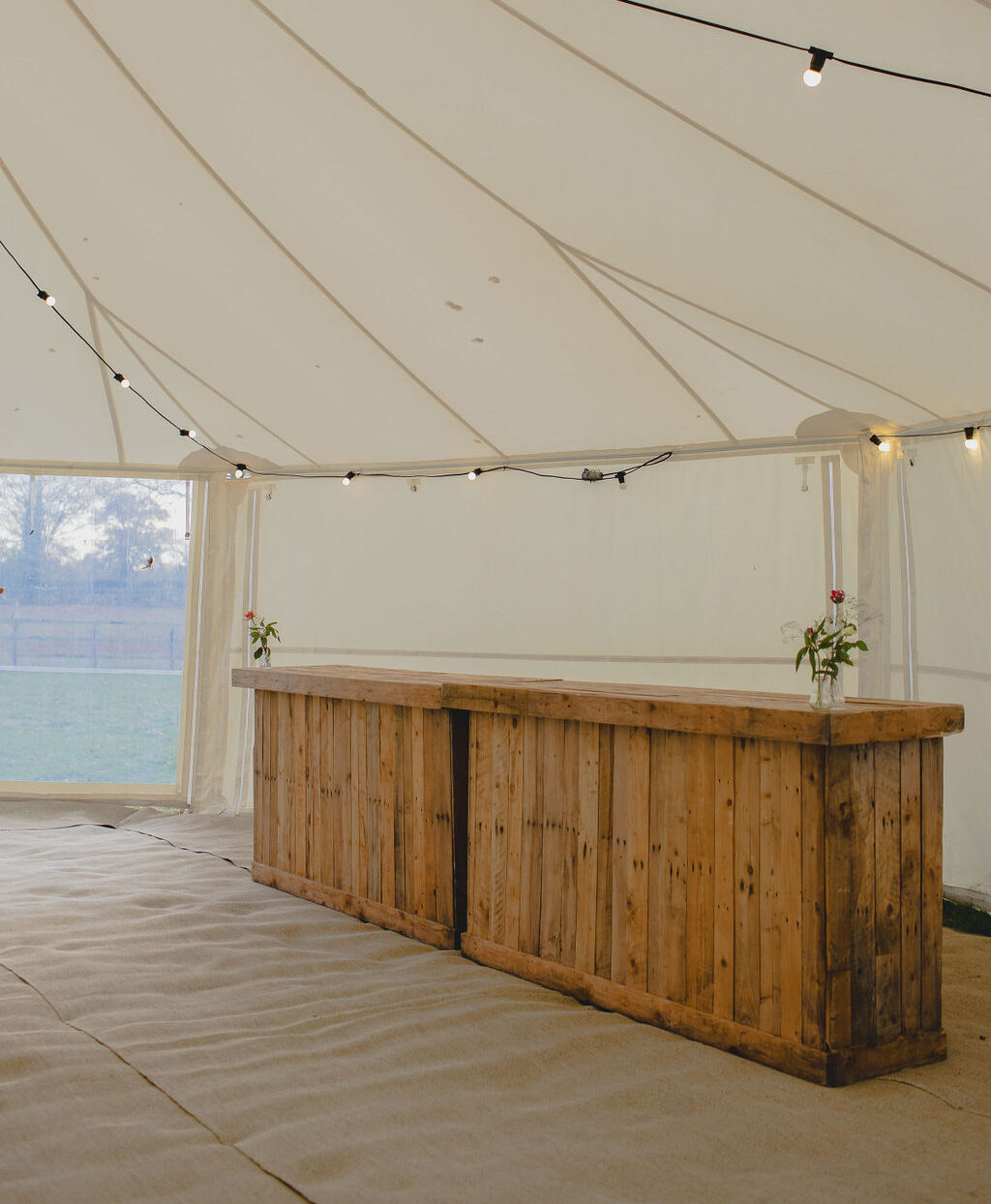 rustic wooden bar in marquee